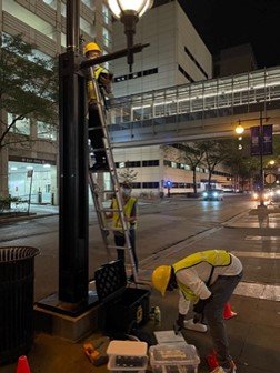 Workers installing cameras for CDOT project